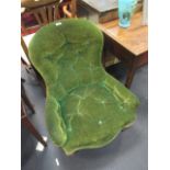 A Victorian button upholstered armchair in a green fabric