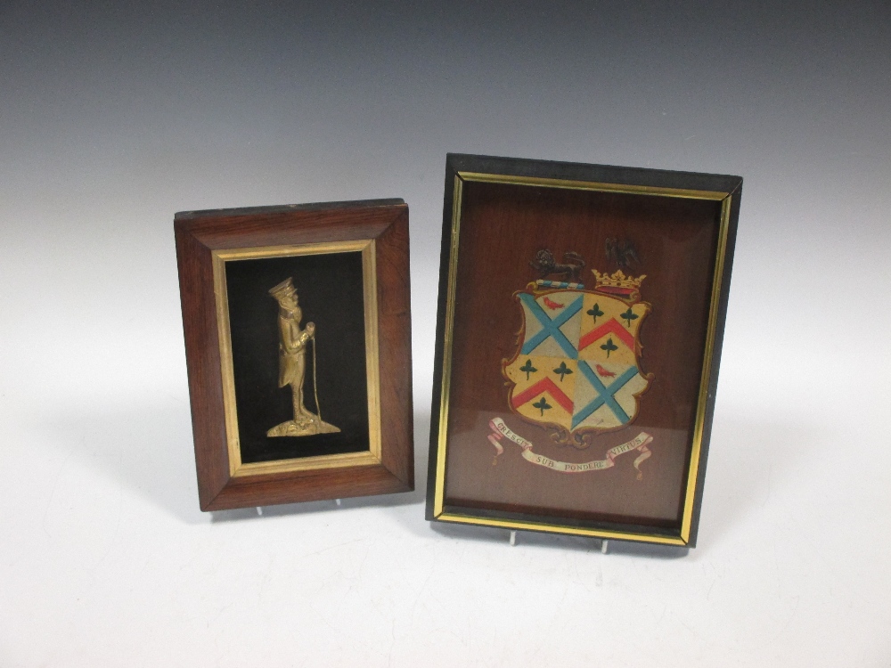 A rosewood framed ormolu profile possibly of Paul Kruger together with a framed quatered armorial