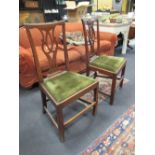 A pair of early 19th Century elm and fruitwood country chairs with pierced splat backs and drop in