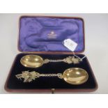 A cased pair of silver gilt spoons with handles modelled as ships, London 1908, 4.8oz