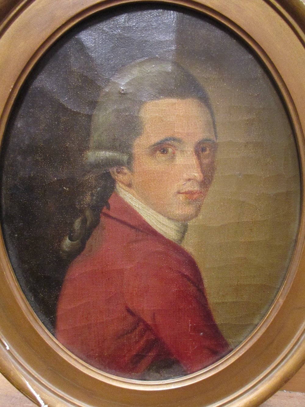 English School, 18th century, portrait of a gentleman in a red jacket, oval,