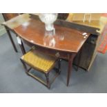 A Regency mahogany bow front side table, fitted with three drawers, 78 x 102 x 52cm