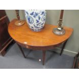 A George III mahogany 'D' end table, the top inlaid with 'bat wing', 119cm wide