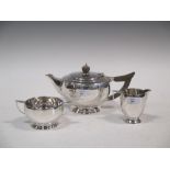 A silver three piece tea set