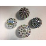 Four Peter McDougall glass paperweights, comprising a latticino crown, a carpet ground millefiori, a