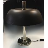 A 1970's table lamp, the painted shade pierced through the centre by a chrome column raised on a