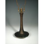 An Art Nouveau bronze lamp base, of bottle form with compressed base cast with stylised foliate