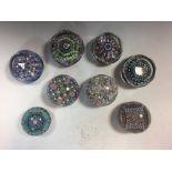 A collection of eight Perthshire glass paperweights, with various millefiori designs, mostly