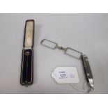 A pair of Art Deco silver lorgnettes and a 9ct stick pin, cased