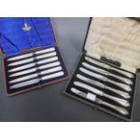 A cased set of fruit knives with mother of pearl handles together with another cased set