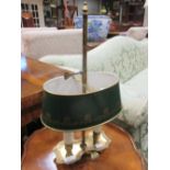 A brass student lamp with green tin plate adjustable shade