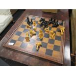 A wooden chess set and a games board
