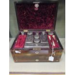 A Victorian rosewood and mother of pearl inlaid lady's travelling toilet box with plate mounted