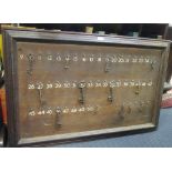 An oak framed key board with an assortment of keys