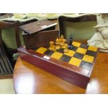 A boxed ebony and boxwood harlequin Staunton pattern chess set together with a board