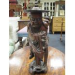 A Chinese carved hardwood figure of a man wearing a straw hat, height 39cm approx