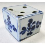 An 18th century blue and white quill holder, the square top painted with five round holes above