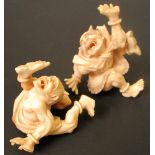 A pair of late 19th/early 20th century marine ivory oni carved in gymnastic tumbling form to stand