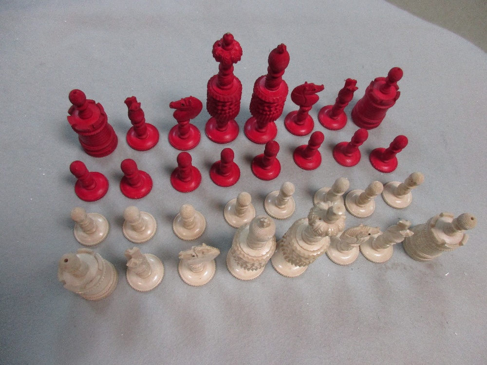 A 19th century red and white bone chess set, each piece ring turned with gadroons and flutes, the - Image 2 of 3