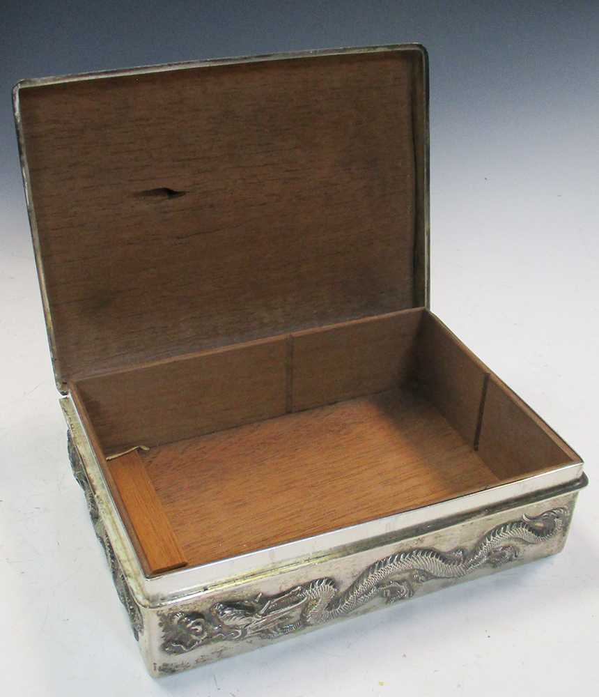 An early 20th century silver double cigarette box, the rectangular hinged lid and sides cast in - Image 4 of 6