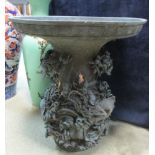 A 19th century bronze vase, the broad flared rim above a baluster body cast in high relief with a