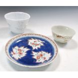 An 18th century blanc de Chine beaker, a tea bowl and a saucer, the octafoil rim of the first