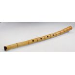 A bamboo recorder style whistle, the open ends red lacquered, four finger stops pierced into its
