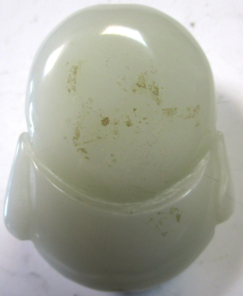 A pale nephrite jade Budai mask toggle, a third eye carved centrally to his forehead as he laughs, - Image 2 of 2