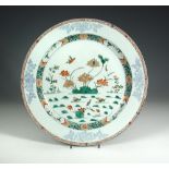 An 18th century famille verte dish painted centrally with two mandarin ducks and a fish swimming