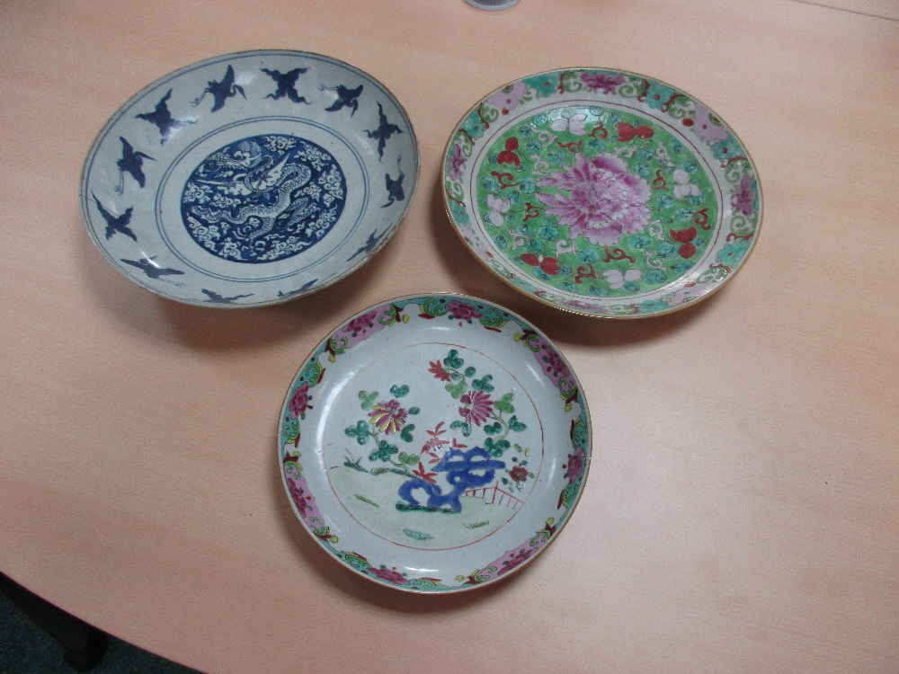 Two 19th century Canton dishes and an earlier blue and white dish, the centre of the smaller