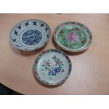 Two 19th century Canton dishes and an earlier blue and white dish, the centre of the smaller