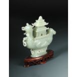 A 1920's nephrite jade boat and pagoda cover, the pale grey green stone carved as a mandarin duck