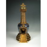 A cloisonne and azurite matrix stone Buddhist stupa, the emblazonned pearl finial above a