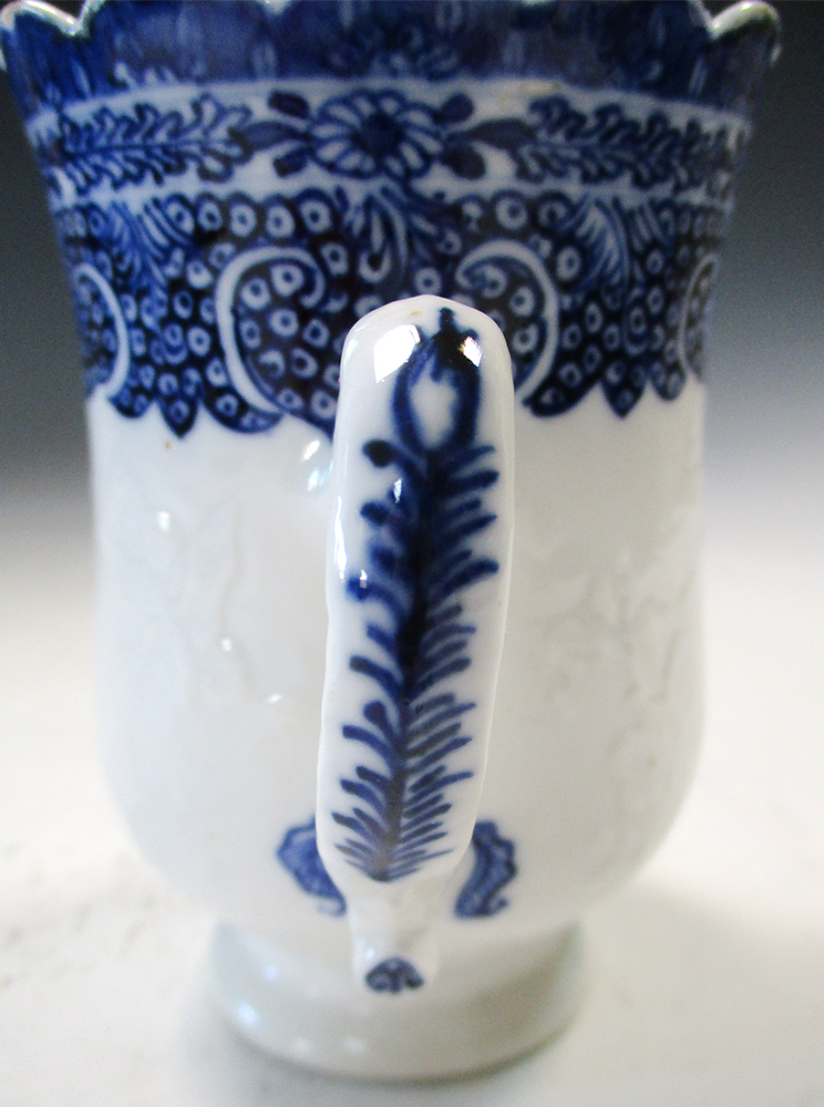 An 18th century blue and white mug, possibly soft paste, the bell shape painted with three - Image 3 of 5