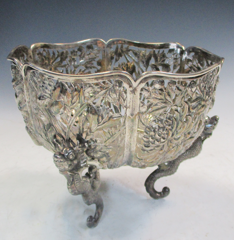 Wang Hing, a reticulated silver bowl, the lobed side with panels of dragons, irises and