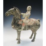 A Han Dynasty grey pottery horse and rider, he wears a white tunic trimmed in black and red