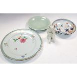 A famille rose, a celadon and an Imari plate together with a figure, the first with flowers