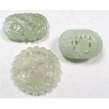 Three various nephrite jade pendants, the hollowed and flattened egg shape of the first pierced