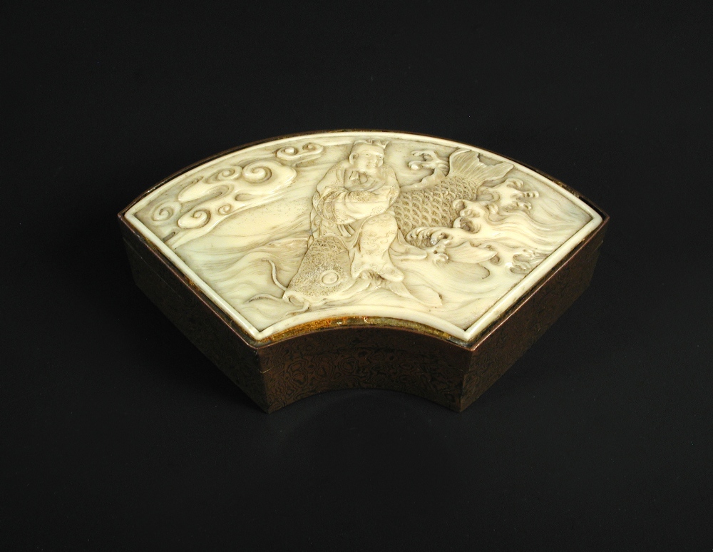 An ivory topped mokume crescent shaped box, the lid carved in relief with Kinko Sennin riding his