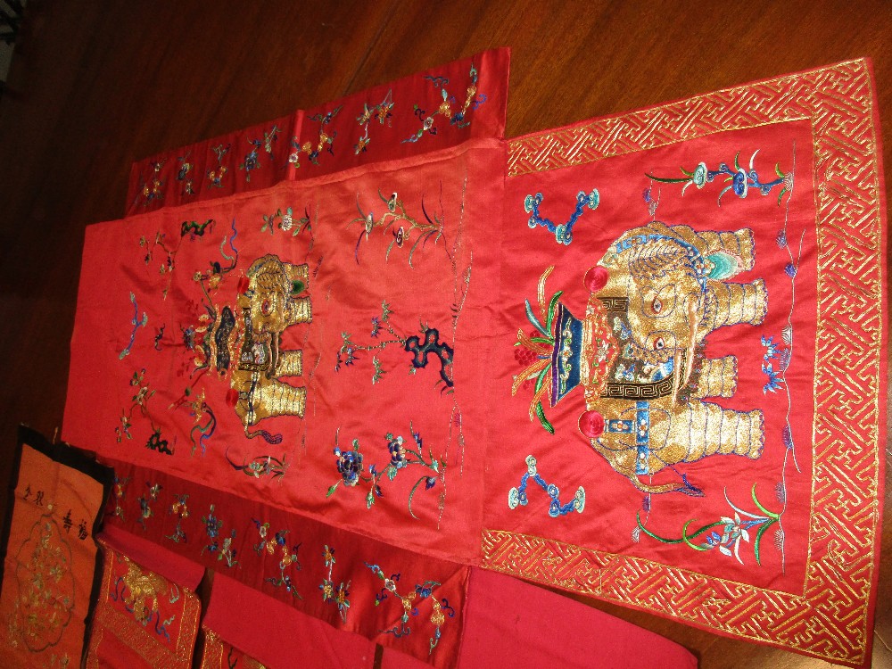 A set of four red silk panels and another, each of the set embroidered in gold thread with a - Image 3 of 4