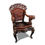 A 19th century hardwood arm chair bearing the Tokugawa mon, the round arch back rail pierced and