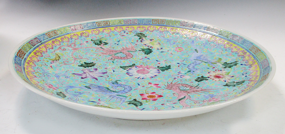 A 20th century turquoise ground dish, the alternating pink and blue dragons radiating about a - Image 2 of 6