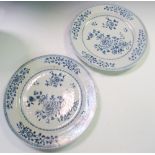 A pair of 18th century Chinese blue and white plates, centrally painted with ribbon tied flowers,