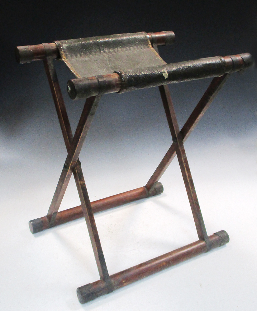 A Samurai warrior's folding stool, the copper capped bamboo X-frame folding out the gilt leather