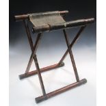 A Samurai warrior's folding stool, the copper capped bamboo X-frame folding out the gilt leather