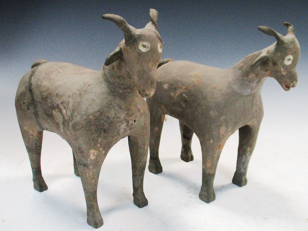 A pair of Han dynasty grey pottery goats, each characterful figure standing four square, its eyes - Image 7 of 7