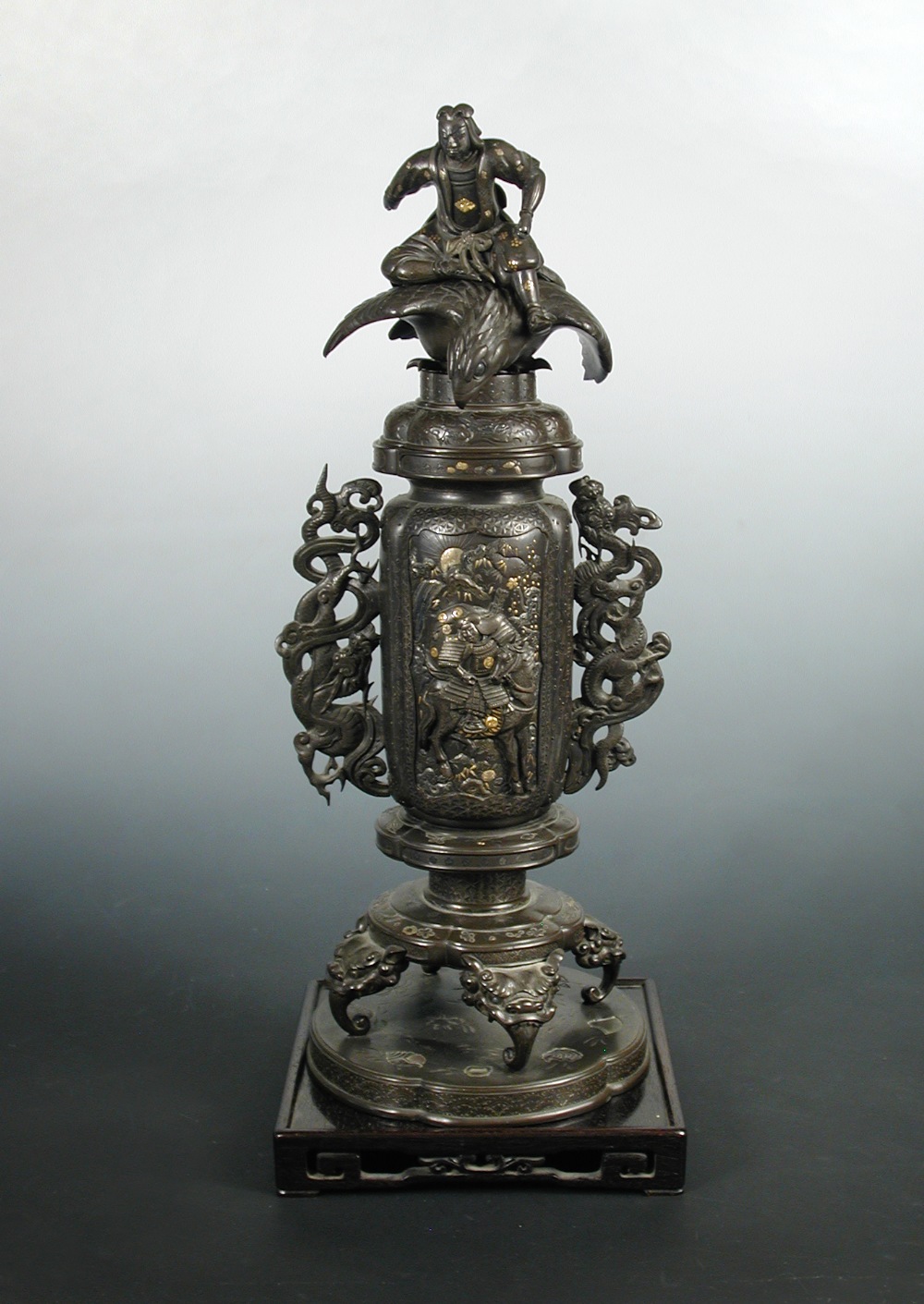 A late 19th/early 20th century inlaid bronze vase and cover, the vase cover surmounted by a