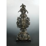 A late 19th/early 20th century inlaid bronze vase and cover, the vase cover surmounted by a