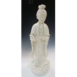 A 19th century blanc de Chinese standing figure of Guanyin, she stands on a cylindrical cloud base