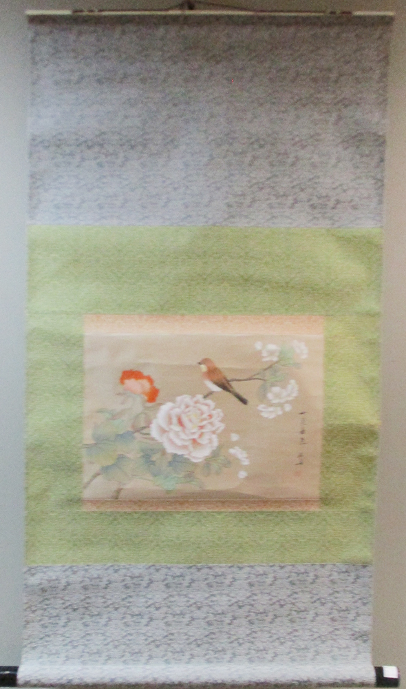 A 20th century scroll painting depicting a bird perched amongst peonies, inscription in black and